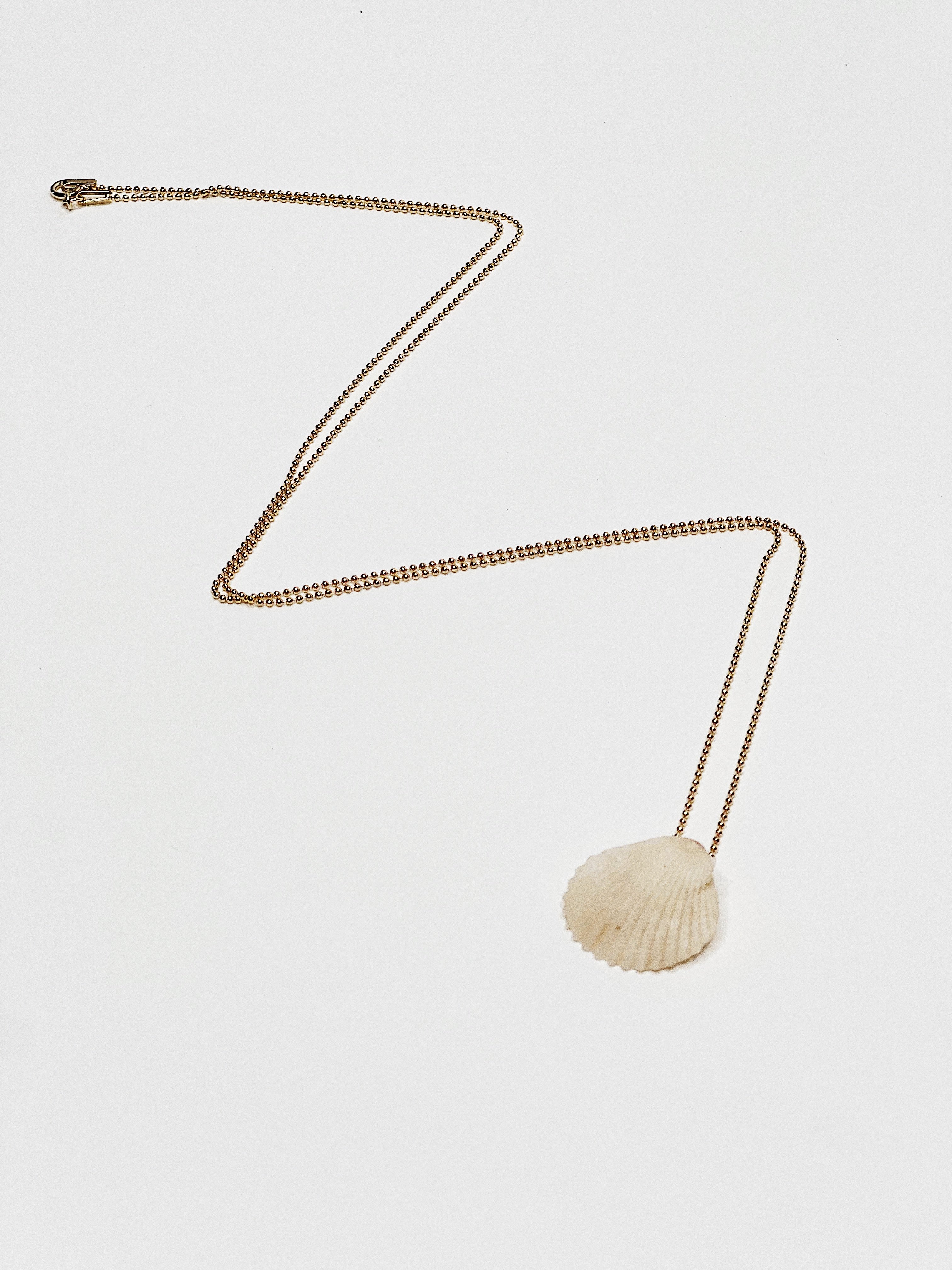 Delicate gold chain necklace with small white shell pendant, handmade on Kaua‘i