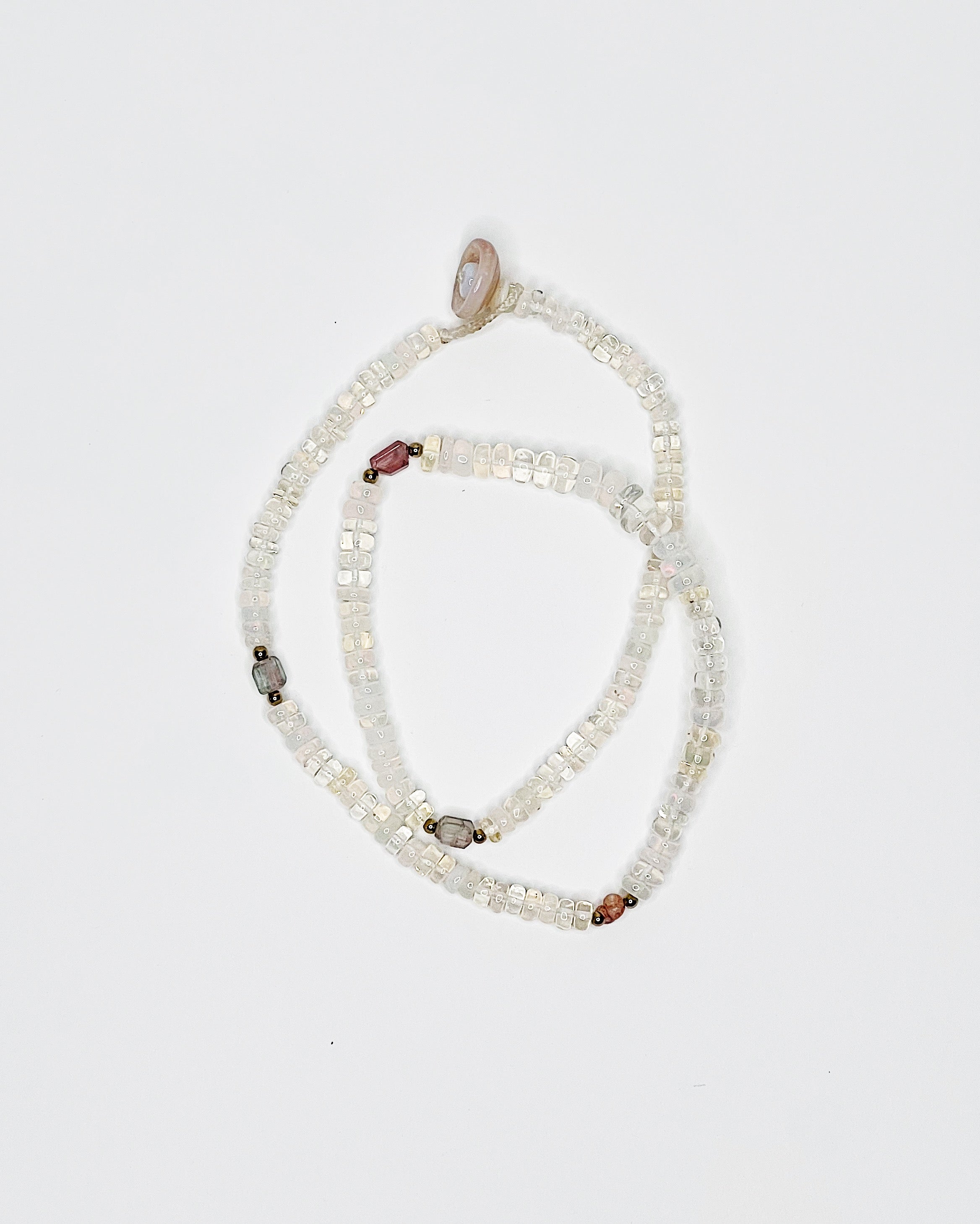 Handmade opal choker with colorful tourmaline accents, puka shell clasp, white background
