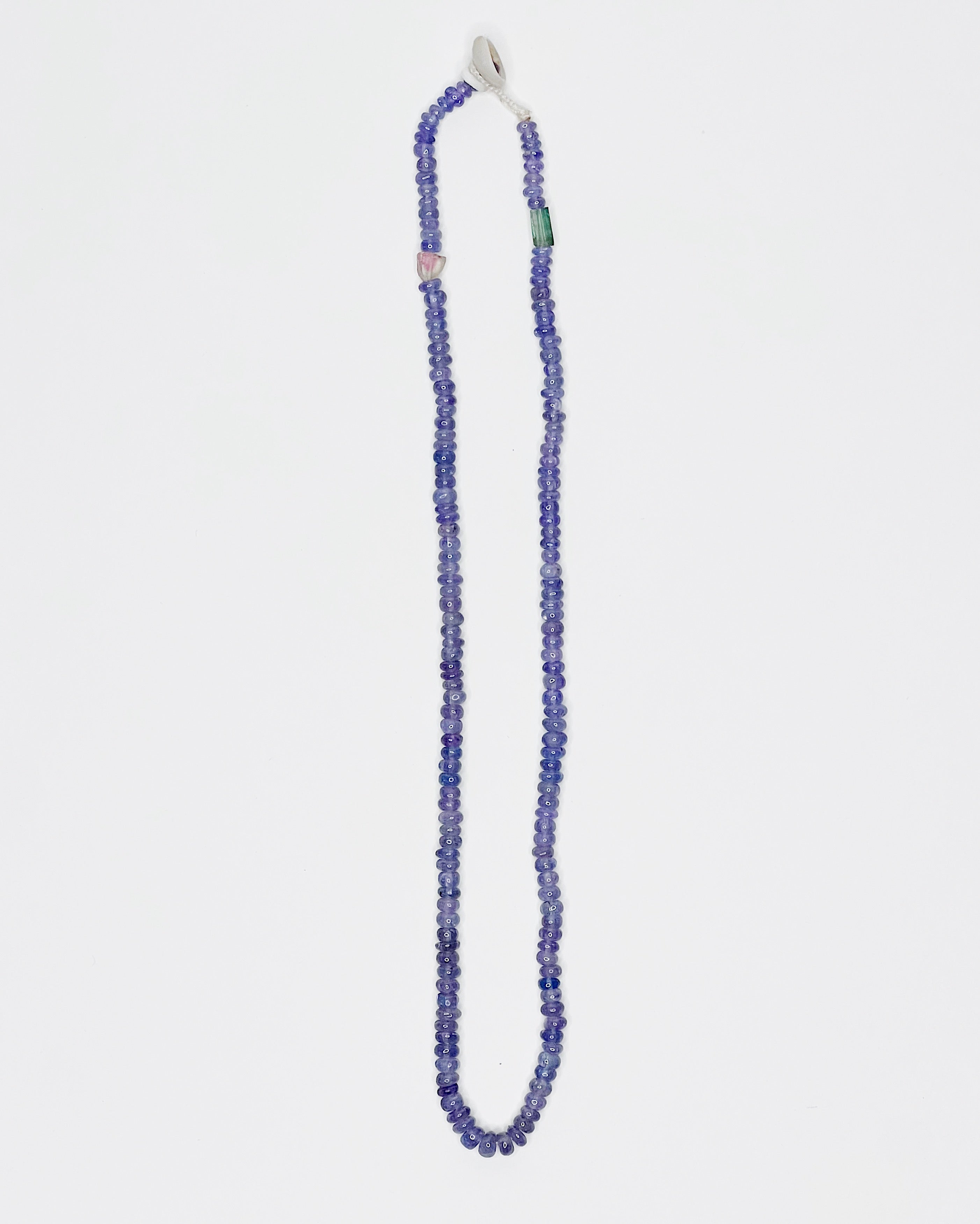 Handmade tanzanite choker with tourmaline accents, finished with puka shell clasp. White background