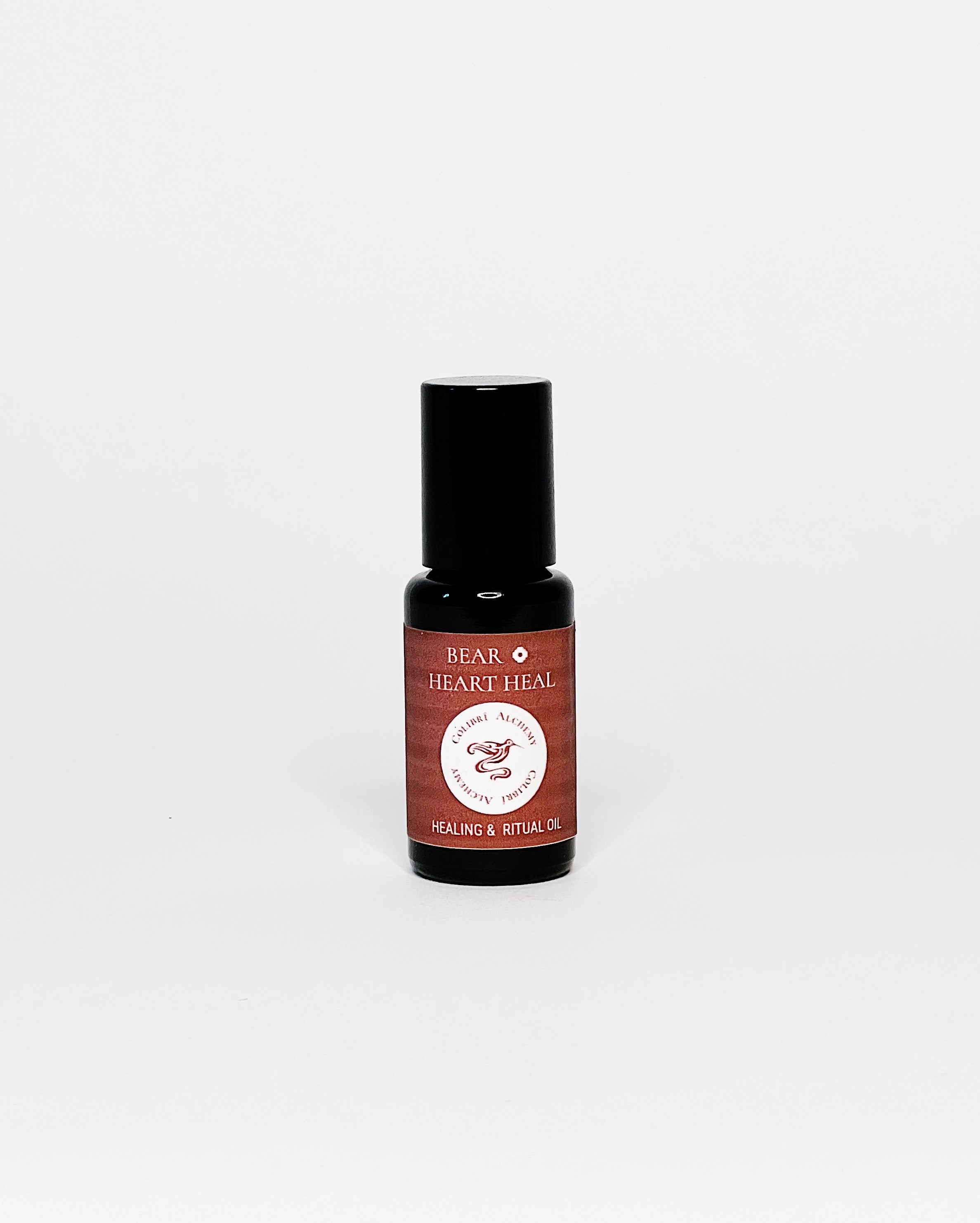 Bear Ritual Oil by Colibrí Alchemy in a dark glass bottle with maroon label, promoting ease, equanimity, and healing.