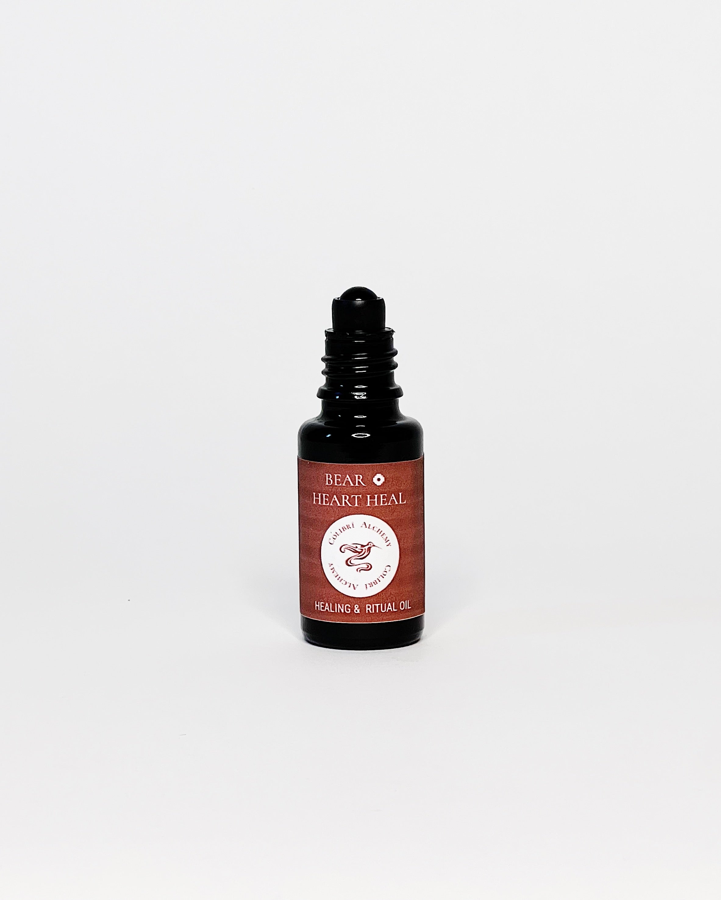 Bear Ritual Oil by Colibrí Alchemy in a dark glass bottle with maroon label, promoting ease, equanimity, and healing.