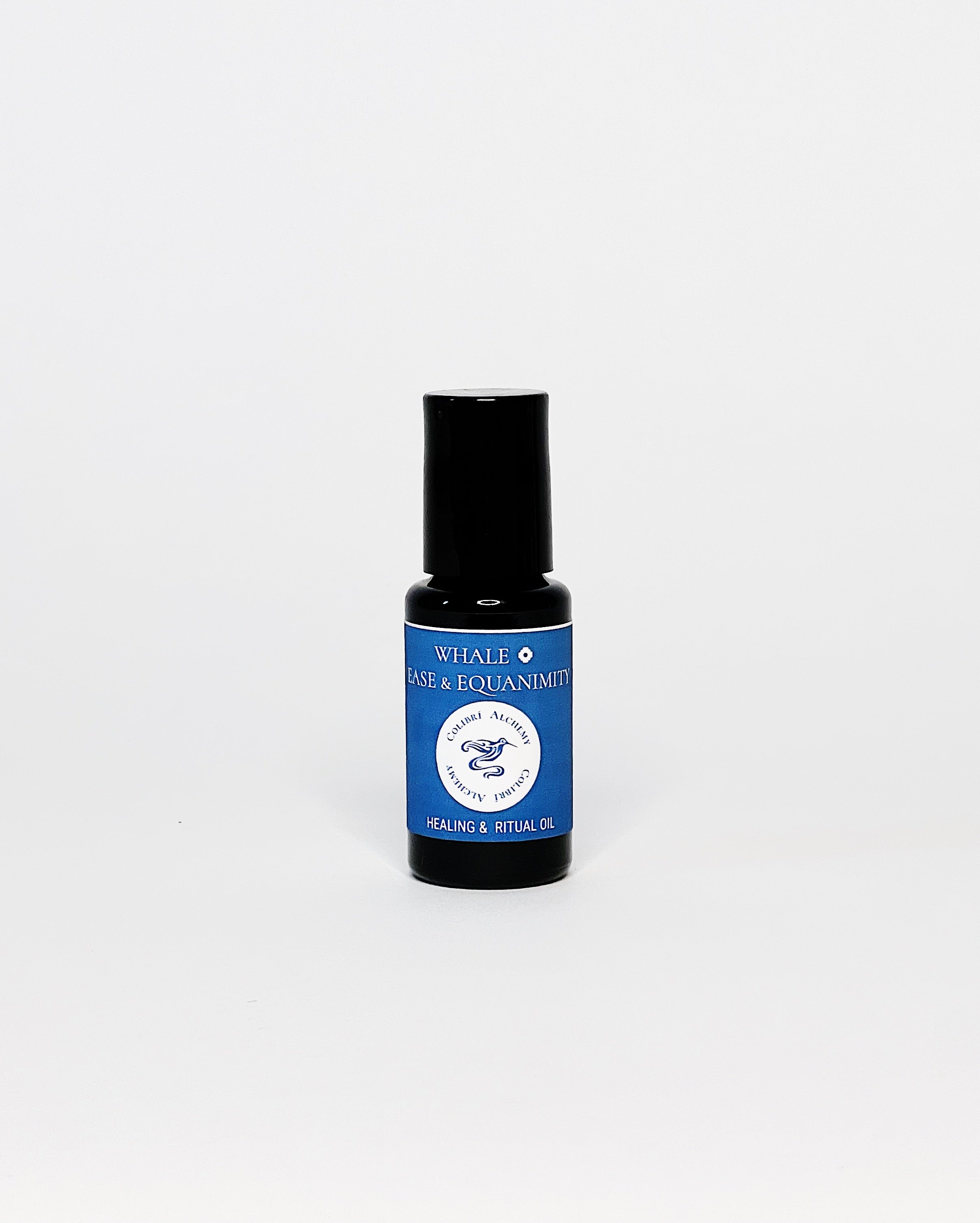 Whale Ritual Oil by Colibrí Alchemy in a dark glass bottle with blue label, promoting ease, equanimity, and healing.