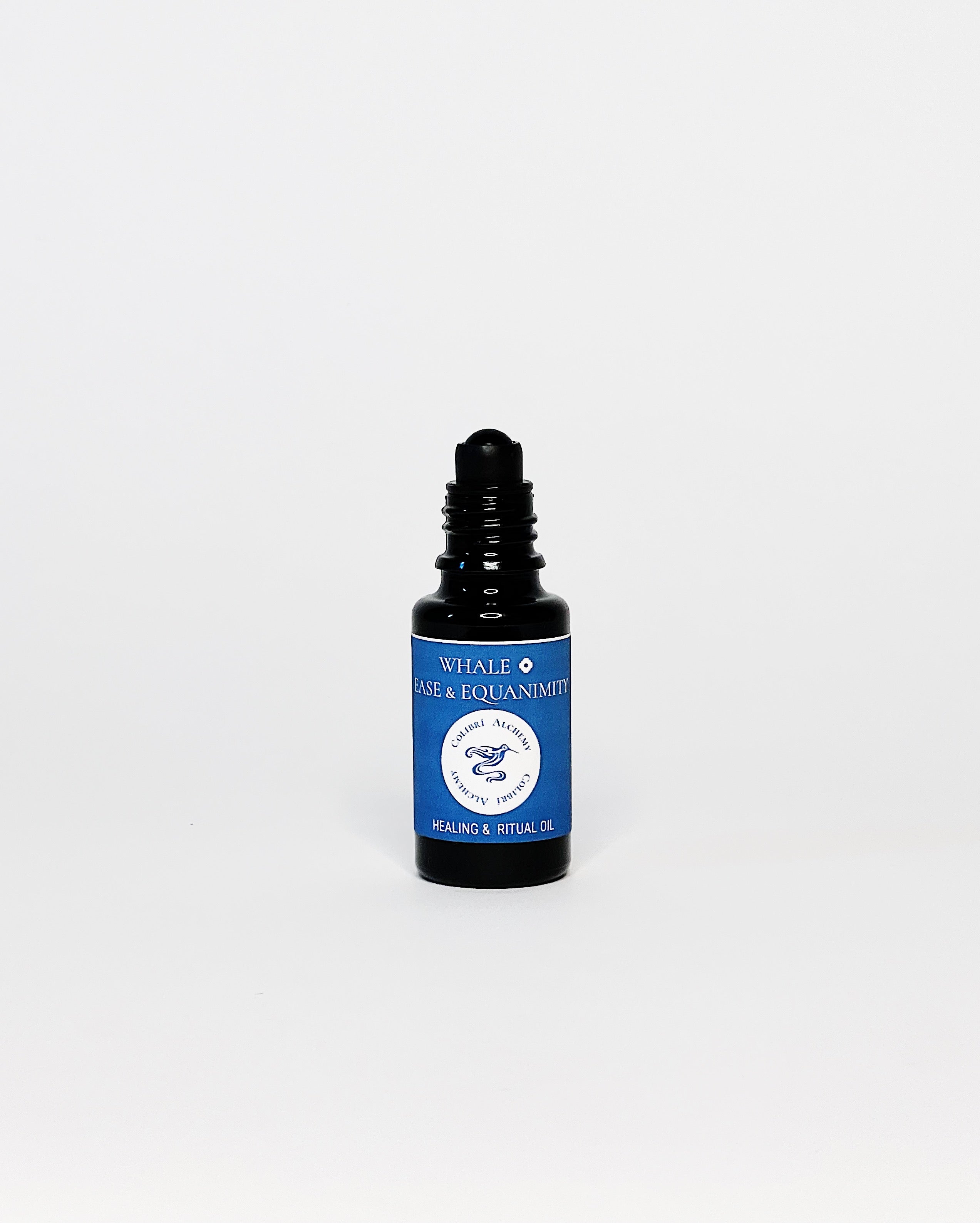 Whale Ritual Oil by Colibrí Alchemy in a dark glass bottle with blue label, promoting ease, equanimity, and healing.