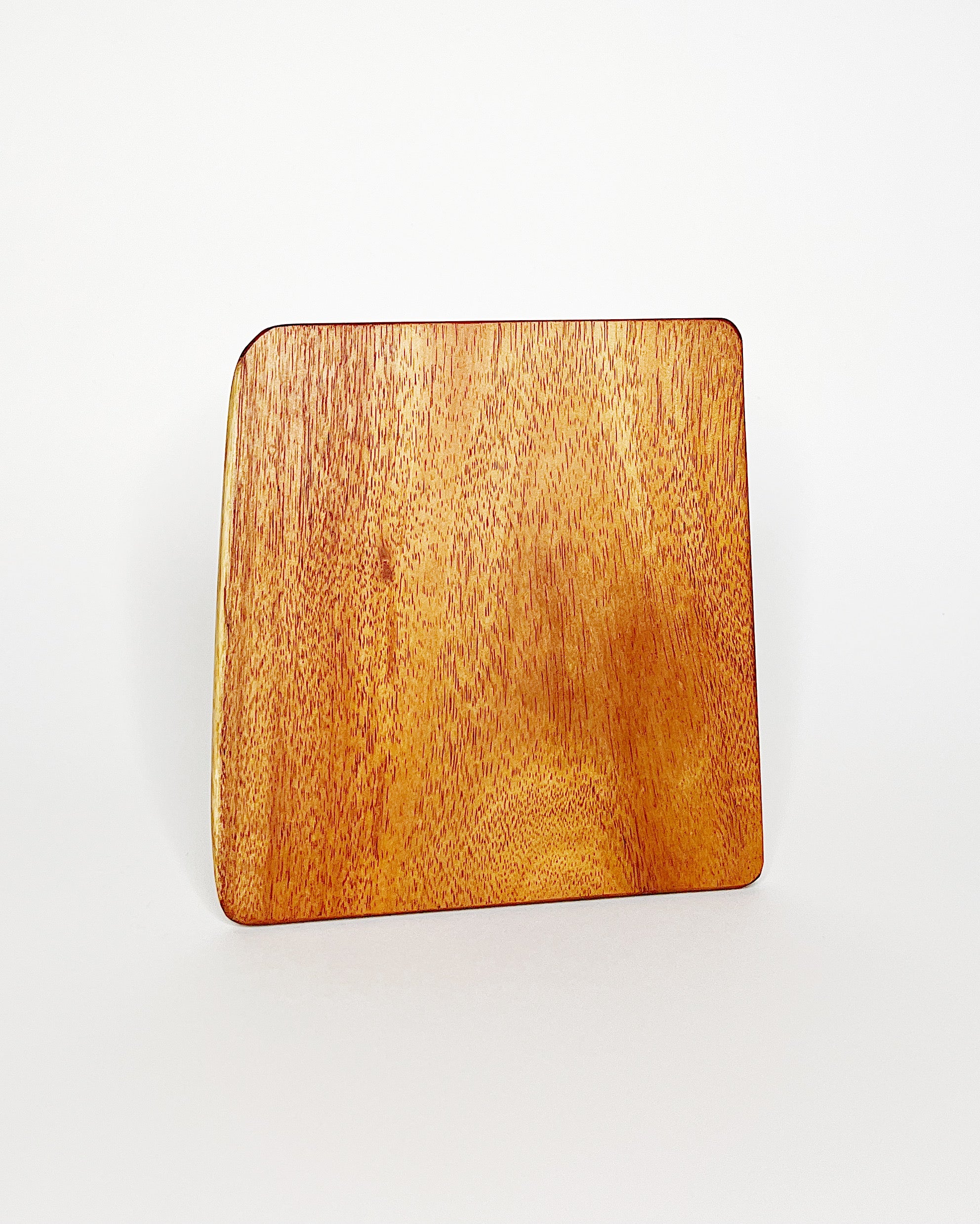 Handmade Hawaiian hardwood cutting board featuring golden yellow and light reddish tones, with a smooth natural grain pattern, displayed on a white background