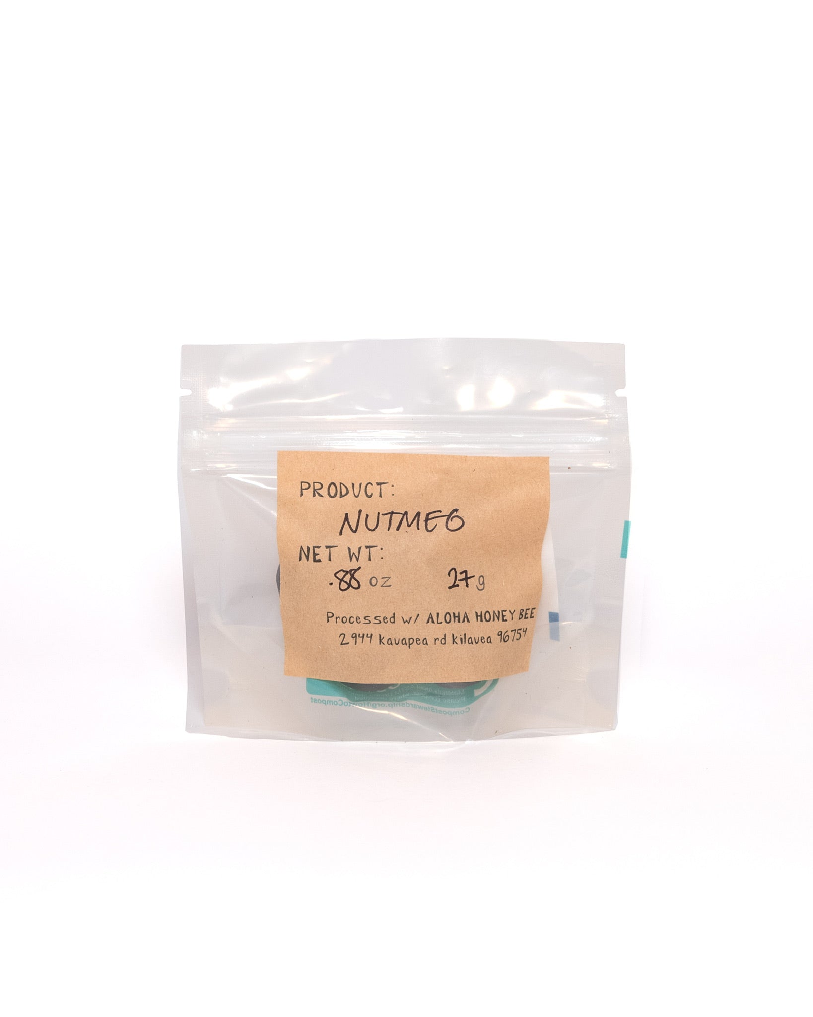 Clear pouch of organic nutmeg with handwritten kraft paper label showing weight and processing info from Aloha Honey Bee