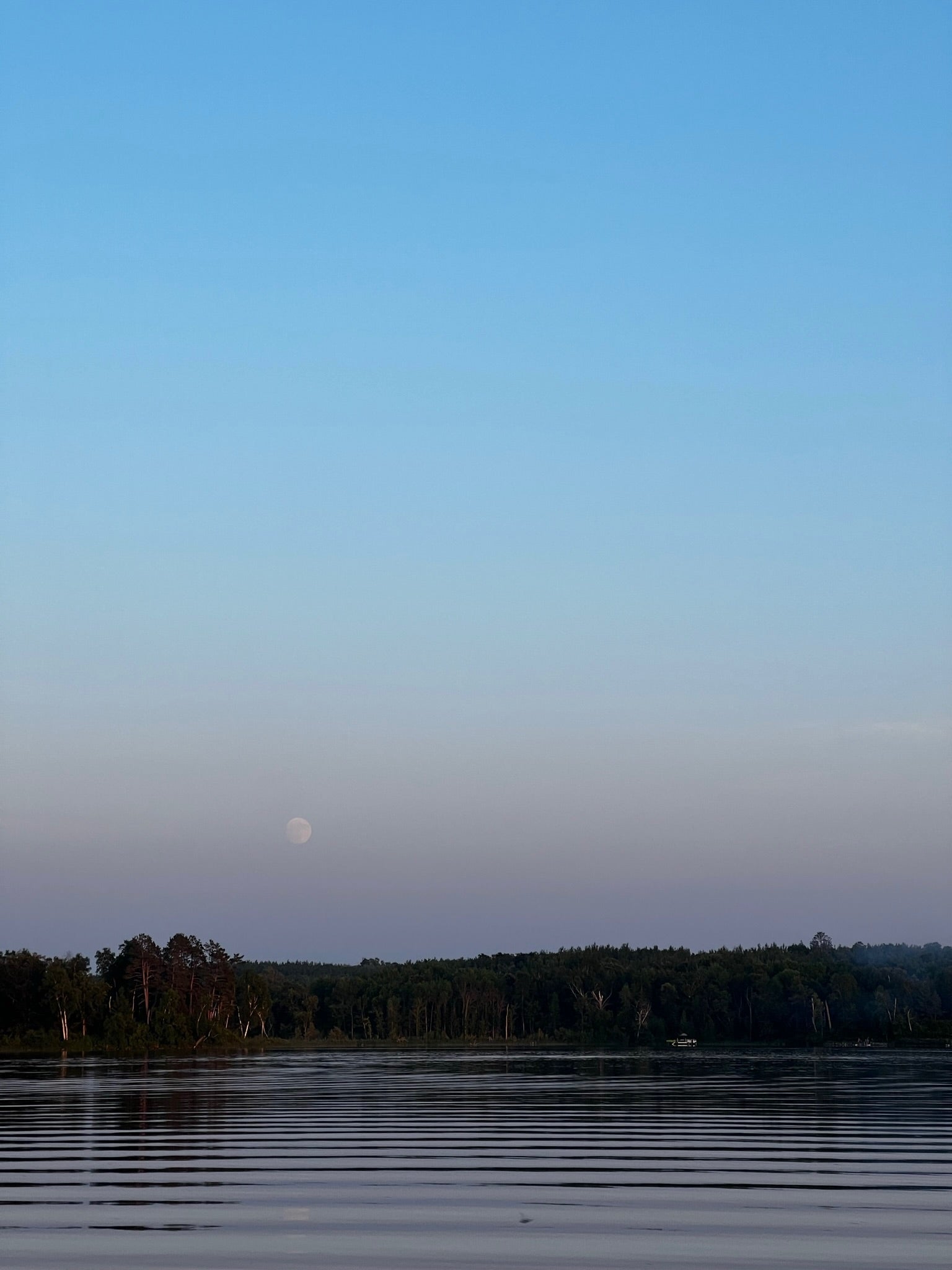 Beautiful evening sky on a lake in minnesota with moon rising