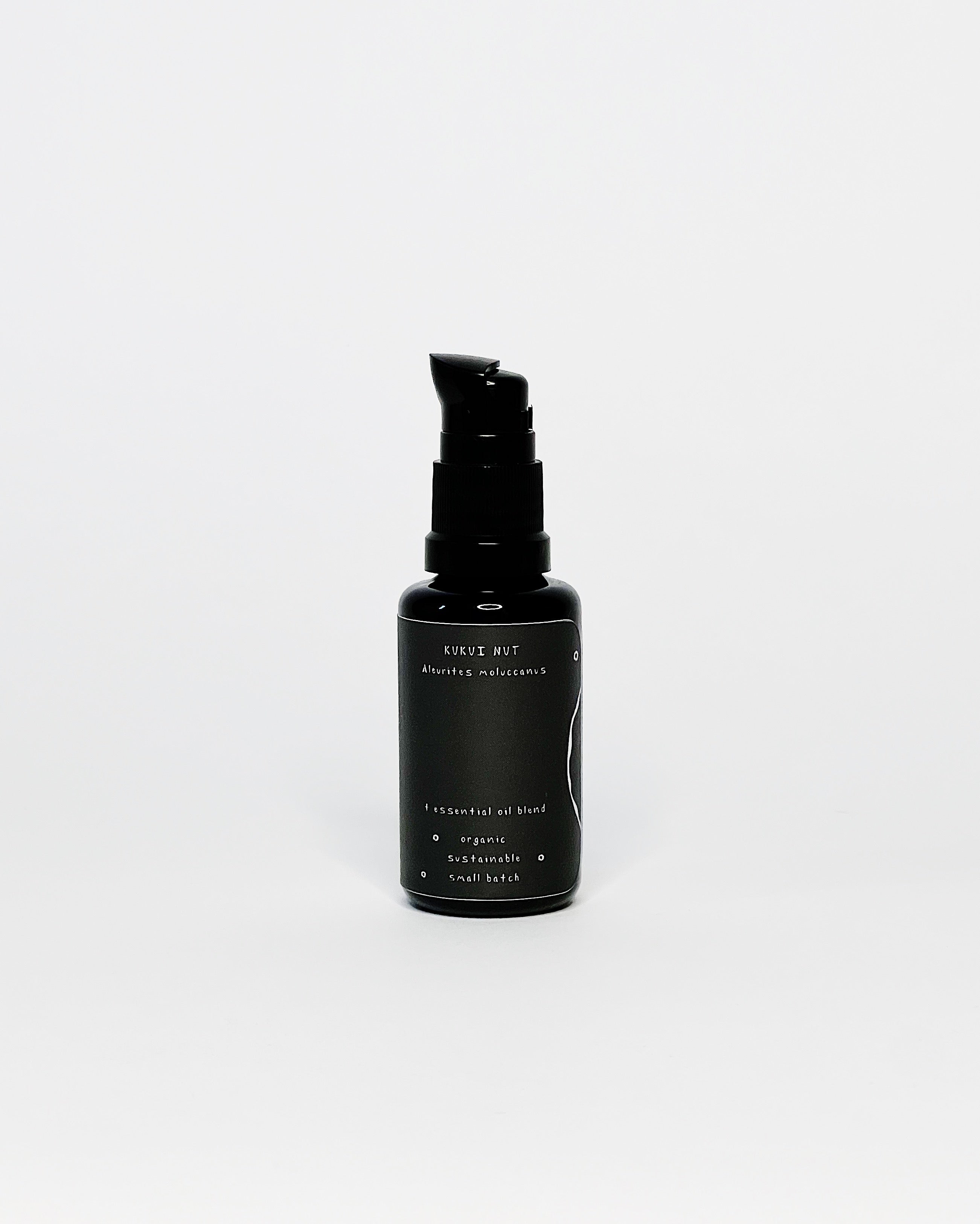 Black glass bottle of ʻOhi ʻOhi La‘au Seasonal Ethnobotanical Oil with a pump top, featuring a white leaf illustration and minimalist label on a white background